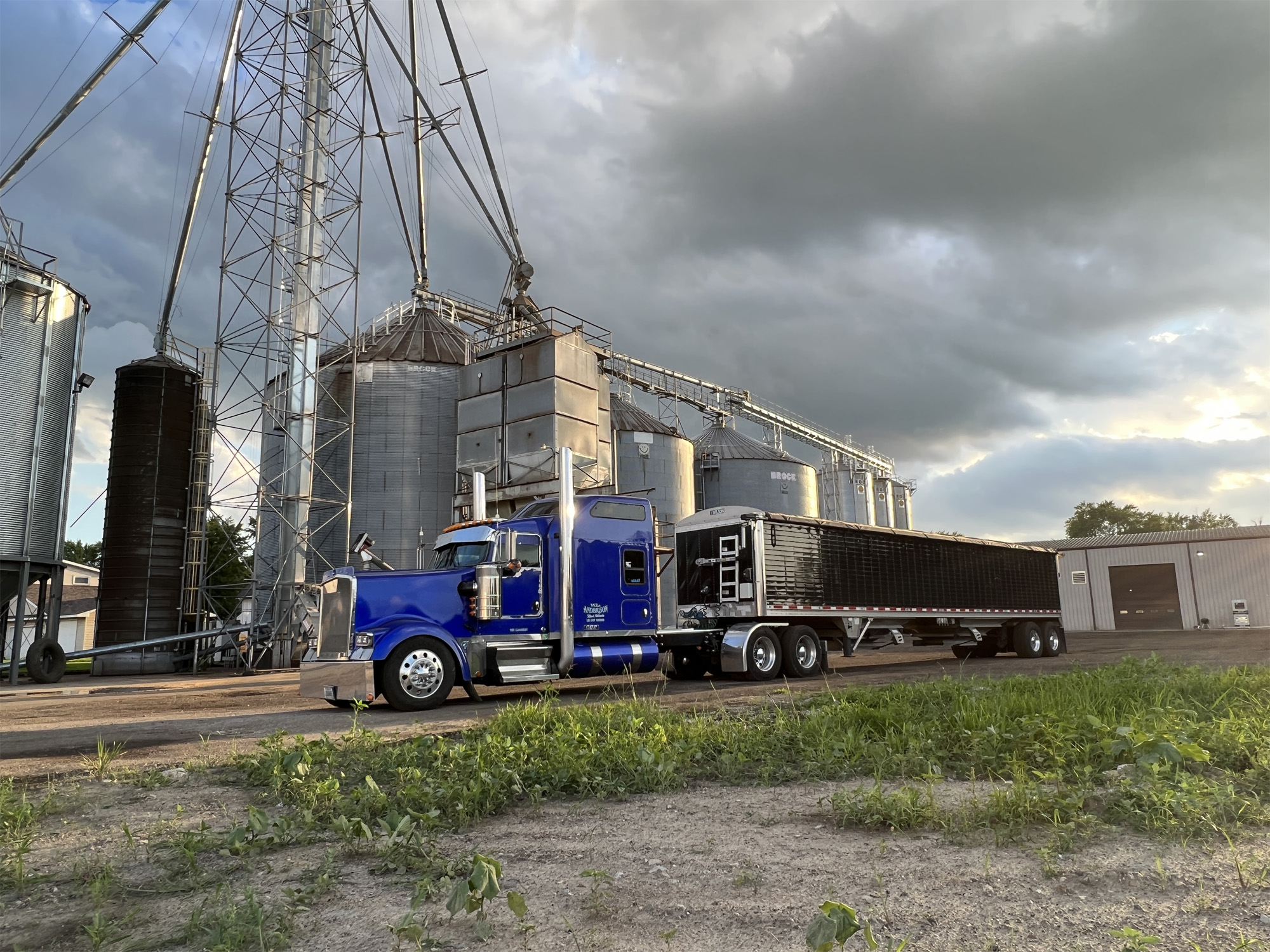 semi truck in front of grain elevator